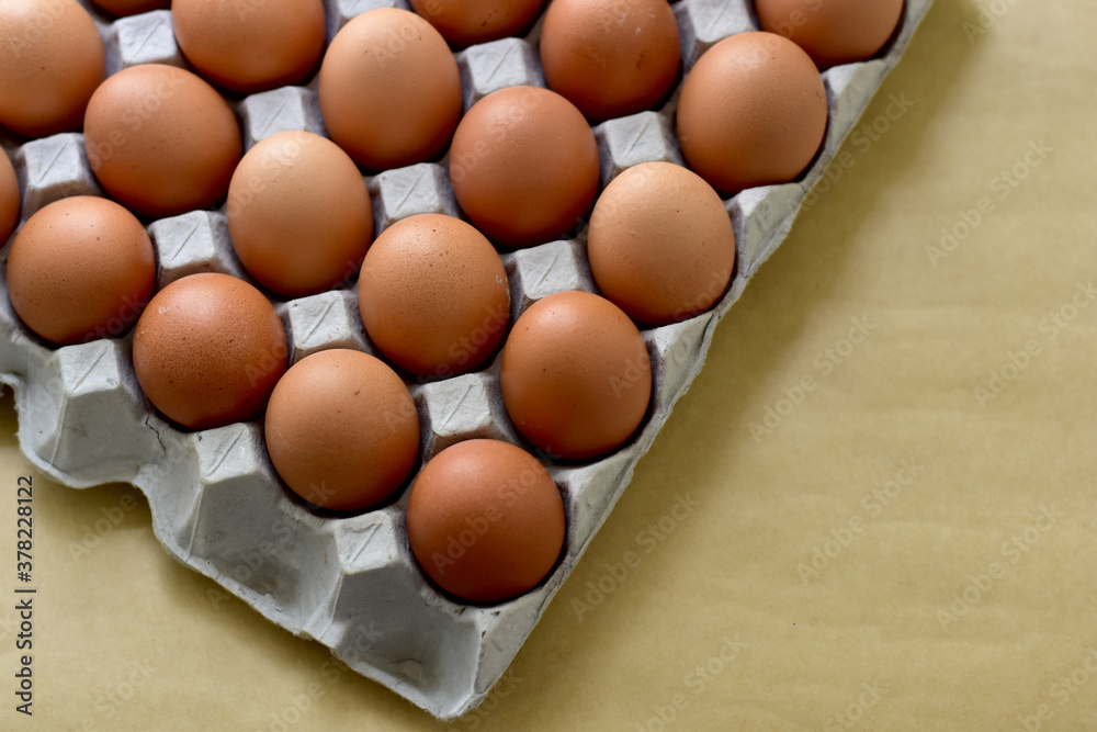 Close up Raw Brown Chicken Eggs, Easter eggs In Paper Container, selective focus points.