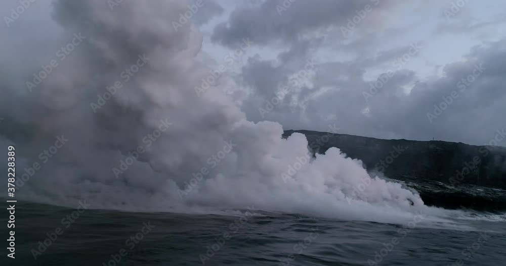 Dense smoke from lava flowing into ocean, aerial Dense smoke from lava flowing into ocean, aerial