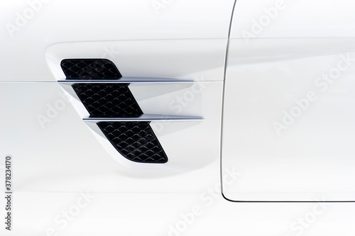 Sport car bodywork, detail of white racing vehicle with air intake, automobile industry