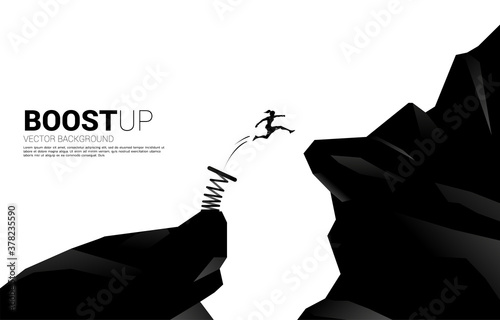 Silhouette of businesswoman jump over the gap with springboard. Concept of boost and growth in business. photo