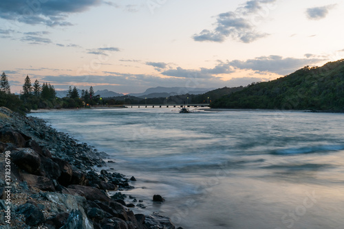 Wide shot of the Tallebudgera creek with burleigh headland to the right
