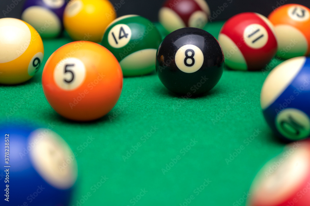 BILLIARD BALLS ON A POOL TABLE. THE EIGHT BLACK ONE IN FOCUS. LEISURE CONCEPT. BILLIARD BALLS ON A POOL TABLE. THE EIGHT BLACK ONE IN FOCUS. LEISURE CONCEPT.