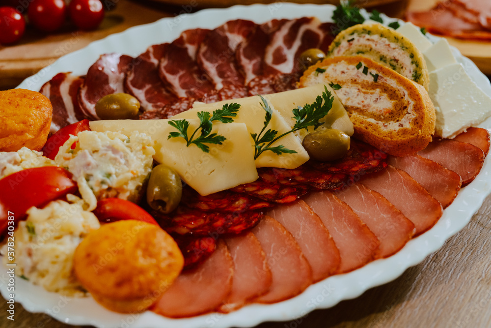 Delicious appetizer served on a plate for a special event. Appetizers for party guests. Charcuterie board Delicious appetizer served on a plate for a special event. Appetizers for party guests. Charcuterie board
