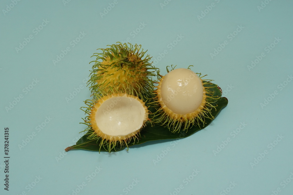 yellow rambutan fruits isolated on green background