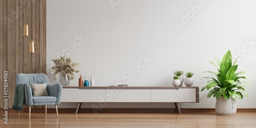 Cabinet TV in modern living room,Interior of a bright living room with armchair on empty white wall background.