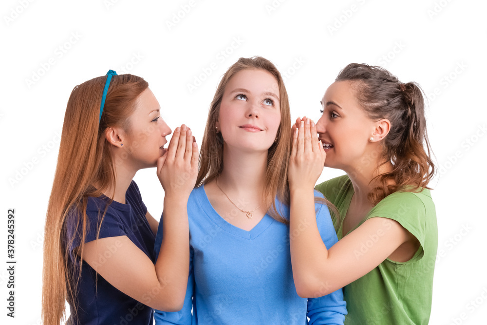 Three Young Caucasian Girlfriends Sharing Their Secrets Whispering to Ears.Isolated Over White Background. Three Young Caucasian Girlfriends Sharing Their Secrets Whispering to Ears.Isolated Over White Background.