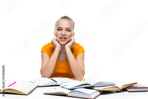 Caucasian Teenager Girl Posing with Notebooks Indoors. Isolated On White.