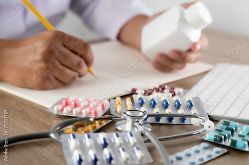 medical doctor writing prescription physician with stethoscope prescribing treatment © onephoto