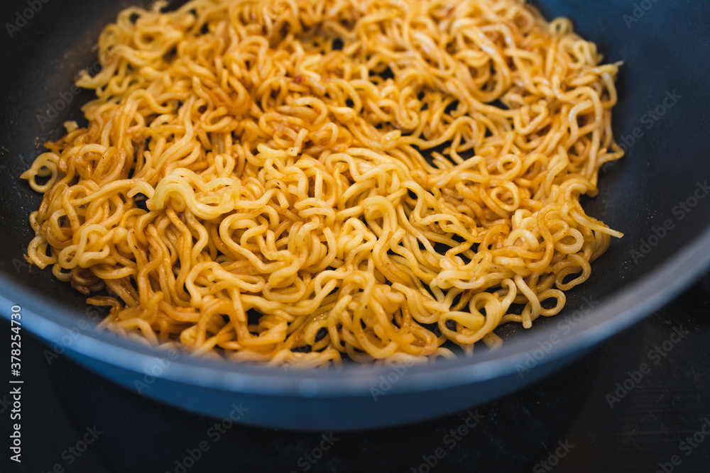 simple food ingredients, noodles cooking in pan on kitchen stove top simple food ingredients, noodles cooking in pan on kitchen stove top