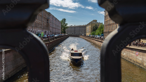 Saint Petersburg, Russia-June, 2020: passing boat on the Griboyedov canal, summer photo