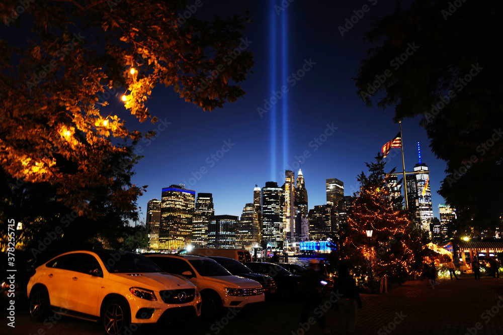Obraz premium Sept 11, 2020 9/11 Memorial Lights next to a Christmas tree overlooking from Downtown Brooklyn, New York City, USA.
