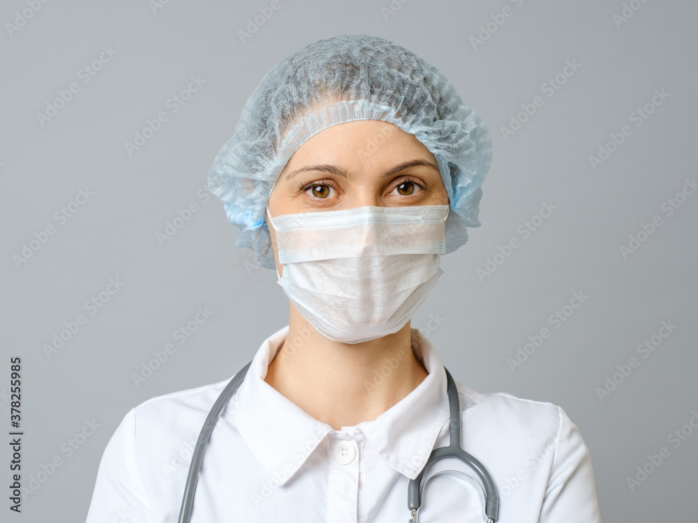 Portrait female doctor in protective medical mask and cap Portrait female doctor in protective medical mask and cap