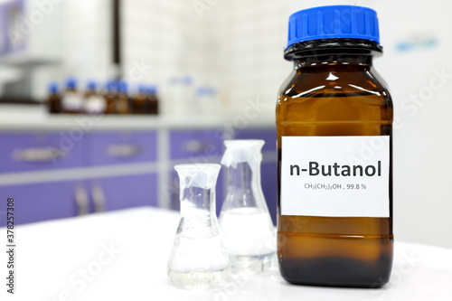 Tableau sur toile Selective focus of butanol or butyl alcohol in glass amber bottle inside a chemistry laboratory with copy space