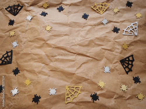 spiders and web shape on brown crumpled paper for halloween background