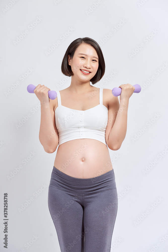 Pregnant woman is doing exercises at the gym Pregnant woman is doing exercises at the gym