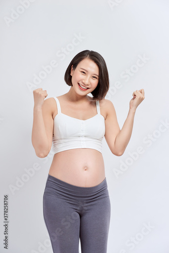 Happy pregnant woman with hands up, isolated on white