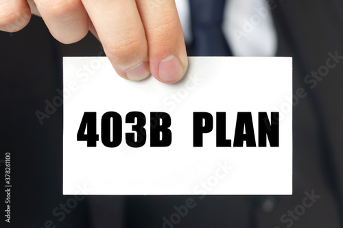 Businessman shows a card with the text - 403B PLAN