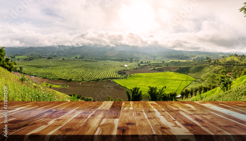 wooden table and mountain farm landscape in sunlight © AungMyo