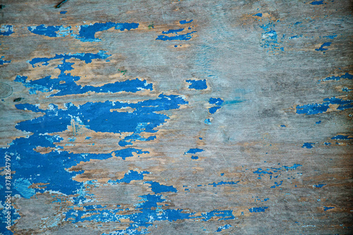 Color-Peel wood texture. Old wooden painted light blue rustic fence, paint peeling background