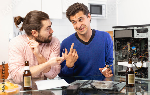 Men do not know how to repair a computer. High quality photo