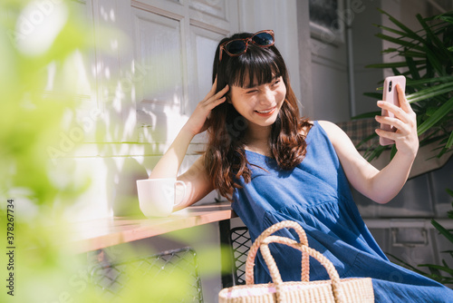 Woman doing vlog with smartphone outdoors. photo