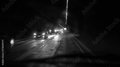 Gorgeous black and white clip of driving POV through a tunnel. Noir feel. photo