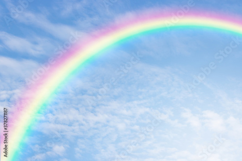 A beautiful rainbow with softlight in blue sky background.