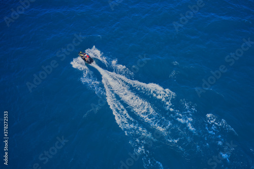 Water scooter movement on turquoise water, aerial view of water scooter