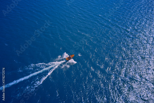 Boat drone photo. Vintage wooden boat in sea. Speed boat at sea, view from above.