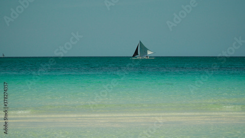 Sailing yacht in lagoon turquoise water  aerial view. Sailing boat glides over the waves  Summer and travel vacation concept