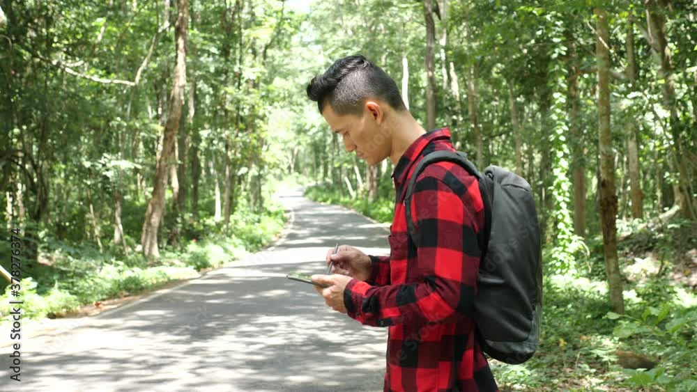 Asian man Hiking Forest survey on nature background beautiful Asian man Hiking Forest survey on nature background beautiful