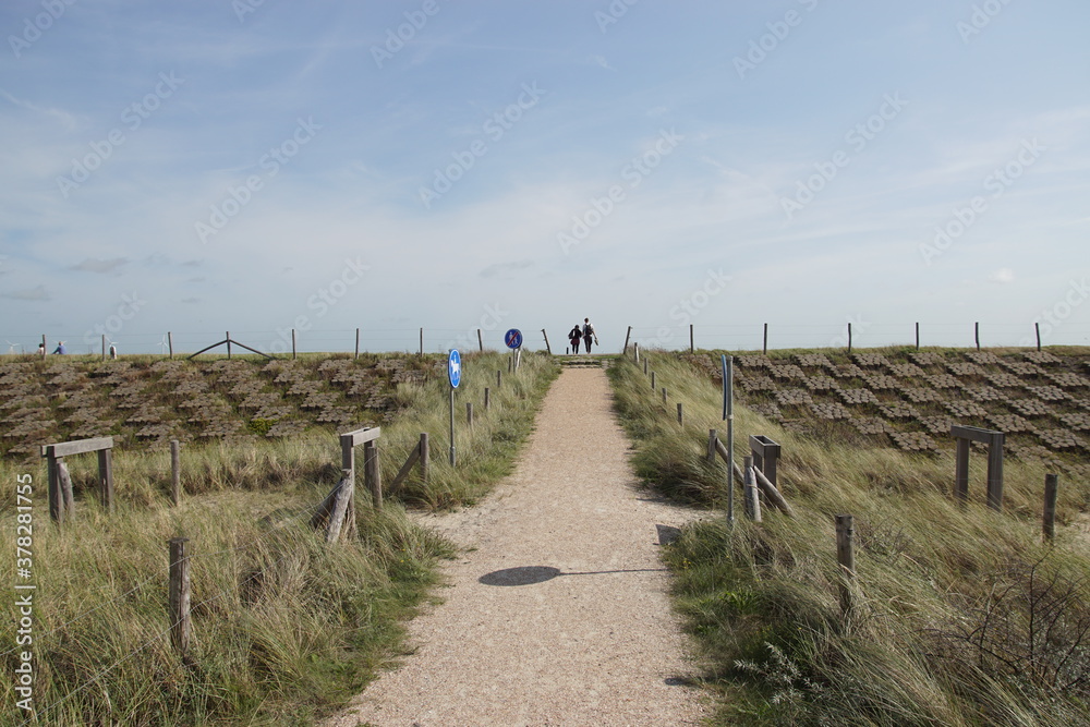 Footpath to the top of a Dutch dyke, seawall as protection against the North Sea (Hondsbossche Zeewering) with 35 million cubic meters of sprayed sand in front of (Hondsbossche Duinen). Netherlands 