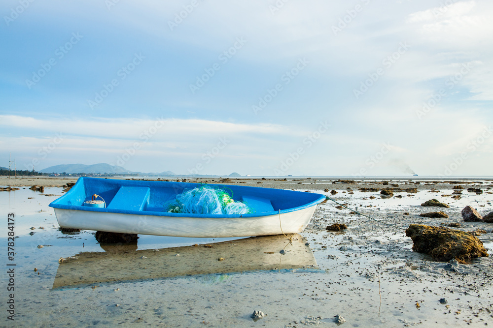 Small Thai Fishing Boat on Sand Beach.