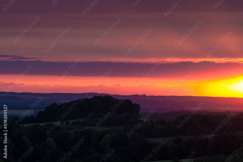 Warm summer sunset over fields and meadows Warm summer sunset over fields and meadows