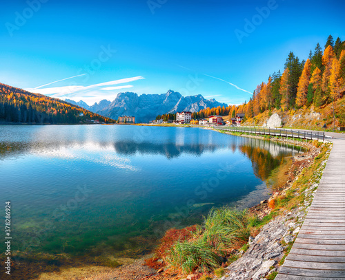 Fantastic sunny view of famous Misurina lake during autumn period