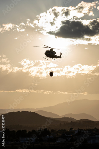 helicopters putting out a fire on a mountain