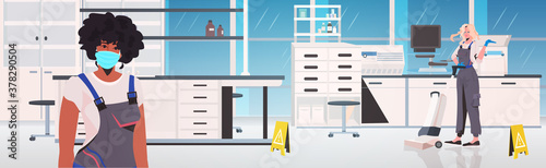 professional cleaners couple mix race janitors using cleaning equipment working together medical laboratory interior horizontal vector illustration