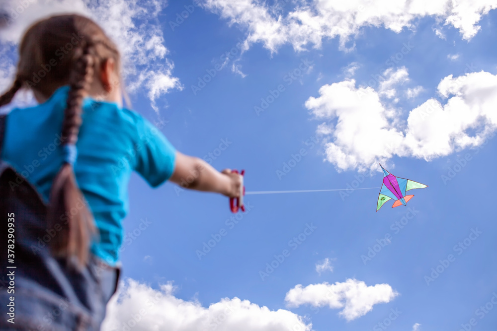 Happy childhood and summertime. Kid having fun and playing with a kite, outdoor