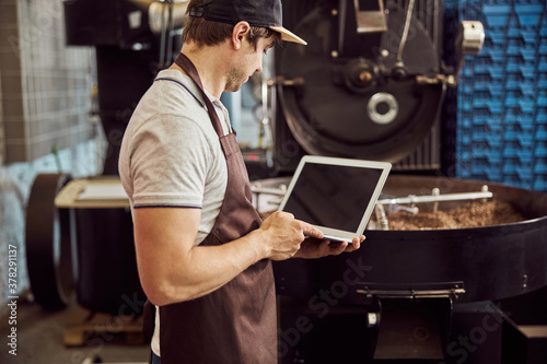 Fotografija Professional roaster using modern laptop at work