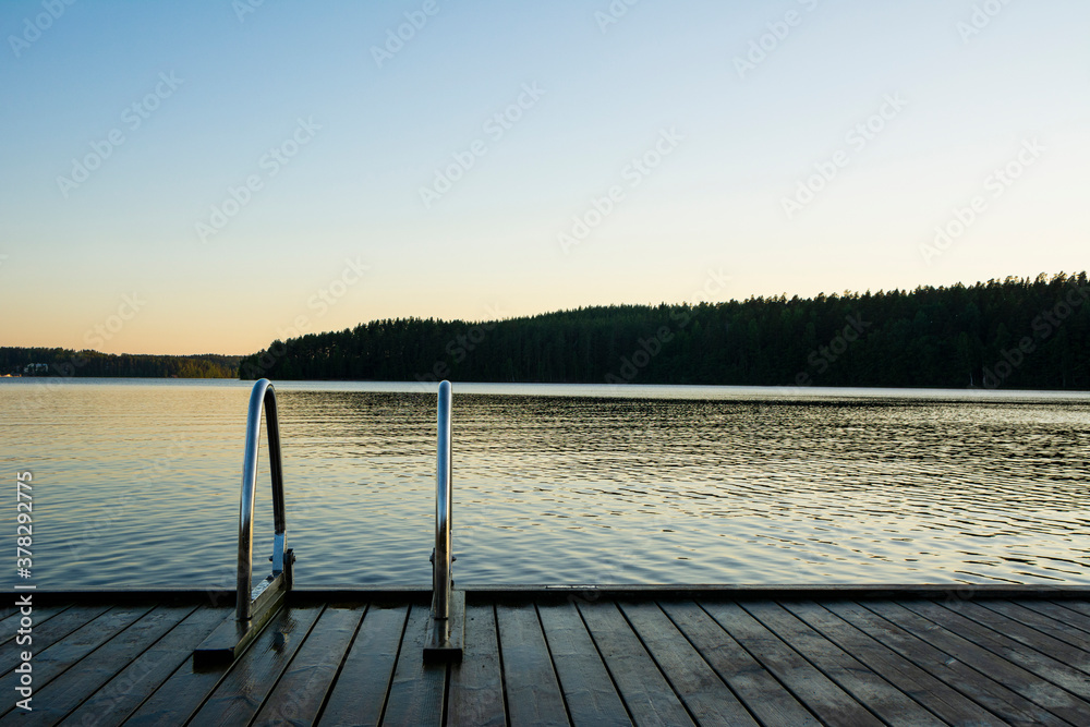 Handrails on the wooden swimming pier and The Lake Saimaa onthe background, Ukonlinna beach, Imatra, Finland