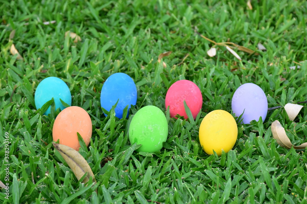 Closeup of Variety of colorful Easter eggs on grass at Thailand.