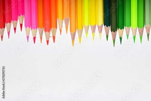 Many Color pencils isolated on white background close up. Color pencils for drawing as a background