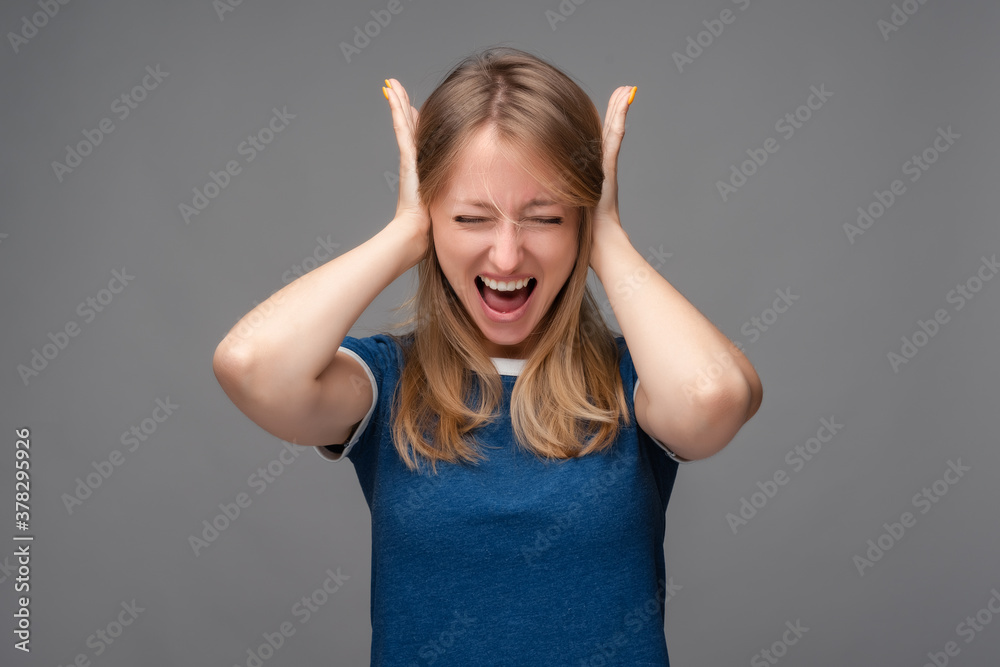 Angry blonde woman screaming and raising hands in anger. Screaming, hate, rage. Negative emotion concept Angry blonde woman screaming and raising hands in anger. Screaming, hate, rage. Negative emotion concept
