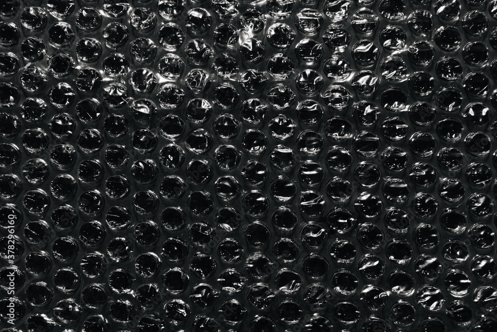 Bubble wrap texture on black background. Packaging with air bubbles. Stock  Photo | Adobe Stock