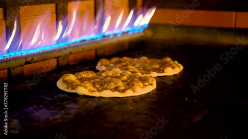 Arabic pizzas cooked inside a gas stove at a restaurant. photo