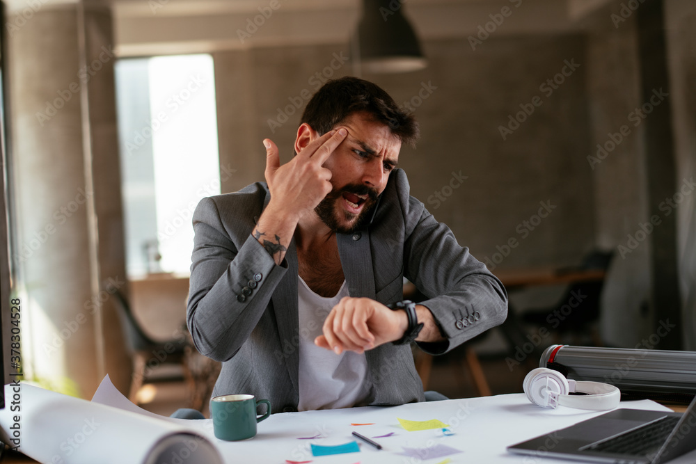 Young businessman working on projects. Handsome businessman in suit working in the office.... Young businessman working on projects. Handsome businessman in suit working in the office....