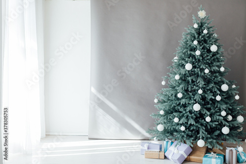 Blue Christmas tree with pine decor gifts for the new year in the interior
