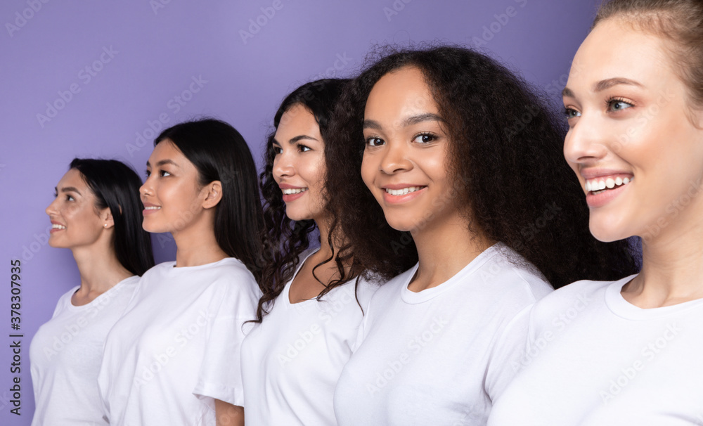 Multicultural Ladies Posing Standing In A Row Over Purple Background Multicultural Ladies Posing Standing In A Row Over Purple Background