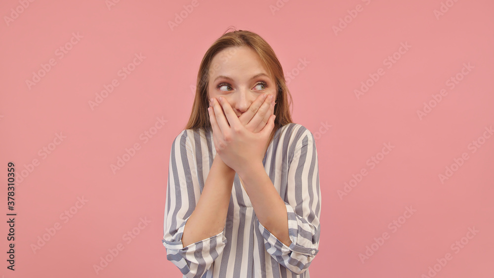 Shy young caucasian woman covering her mouth with hands. Isolated on pink background. High quality photo Shy young caucasian woman covering her mouth with hands. Isolated on pink background. High quality photo
