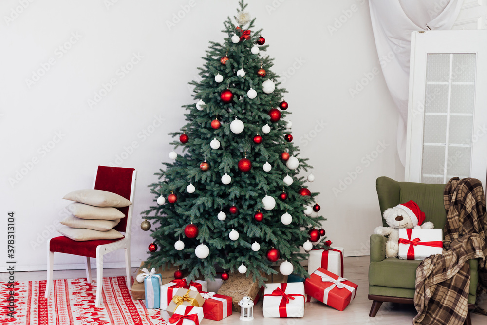 Christmas tree in the white room decor pine for the new year with gift card